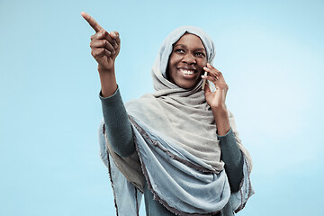 Image showing The beautiful young black muslim girl wearing gray hijab, with a happy smile on her face.