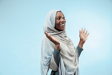 Image showing The beautiful young black muslim girl wearing gray hijab, with a happy smile on her face.