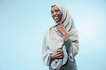 Image showing The beautiful young black muslim girl wearing gray hijab, with a happy smile on her face.