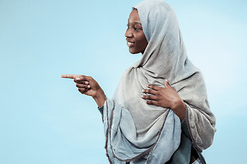 Image showing The beautiful young black muslim girl wearing gray hijab, with a happy smile on her face.