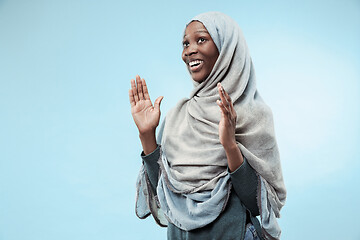 Image showing The beautiful young black muslim girl wearing gray hijab, with a happy smile on her face.