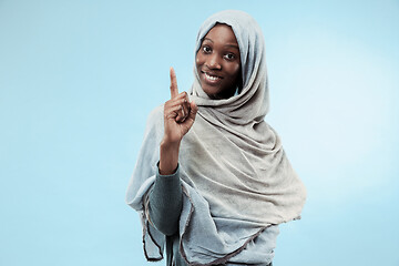 Image showing The beautiful young black muslim girl wearing gray hijab, with a happy smile on her face.