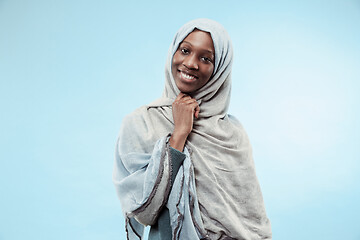 Image showing The beautiful young black muslim girl wearing gray hijab, with a happy smile on her face.