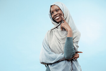 Image showing The beautiful young black muslim girl wearing gray hijab, with a happy smile on her face.