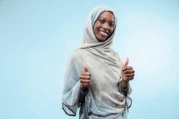 Image showing The beautiful young black muslim girl wearing gray hijab, with a happy smile on her face.