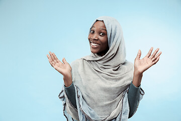 Image showing The beautiful young black muslim girl wearing gray hijab, with a happy smile on her face.