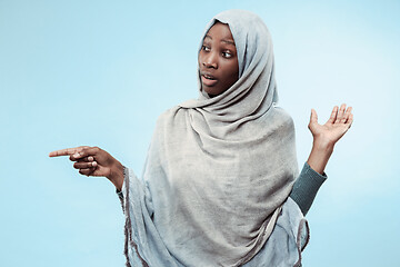 Image showing The beautiful young black muslim girl wearing gray hijab, with a happy smile on her face.