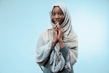 Image showing The beautiful young black muslim girl wearing gray hijab, with a happy smile on her face.