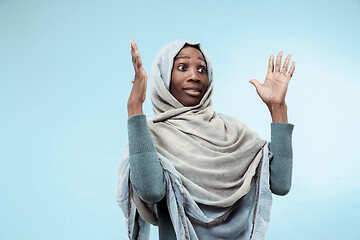 Image showing The beautiful young black muslim girl wearing gray hijab, with a happy smile on her face.