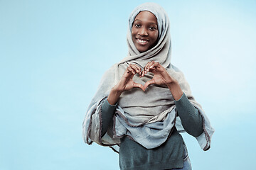 Image showing The beautiful young black muslim girl wearing gray hijab, with a happy smile on her face.