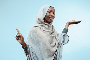 Image showing The beautiful young black muslim girl wearing gray hijab, with a happy smile on her face.