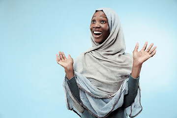 Image showing The beautiful young black muslim girl wearing gray hijab, with a happy smile on her face.