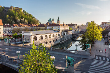 Image showing Aerial drone panoramic view of Ljubljana medieval city center, capital of Slovenia in warm afternoon sun. Empty streets during corona virus pandemic social distancing measures