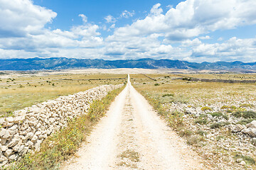 Image showing Dirt road leading trough dry rocky Mediterranean coastal lanscape of Pag island, Croatia in summertime