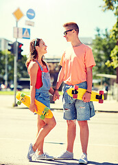 Image showing teenage couple with skateboards on city street