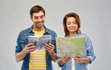 Image showing happy couple of tourists with city guide and map