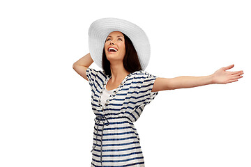 Image showing young woman in striped tunic and sun hat