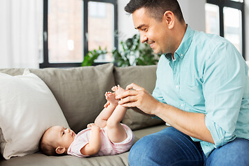 Image showing middle aged father playing with baby at home