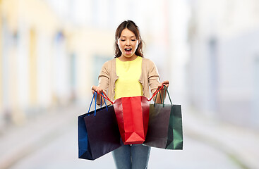 Image showing happy asian woman with shopping bags