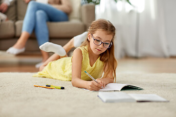 Image showing student girl writing to notebook at home