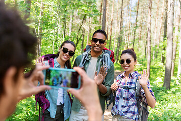 Image showing friends with backpacks being photographed on hike