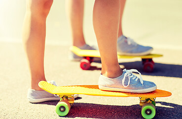 Image showing close up of female feet riding short skateboard