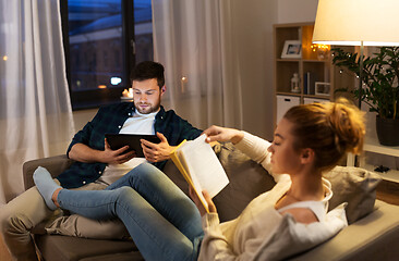 Image showing couple with tablet computer and book at home