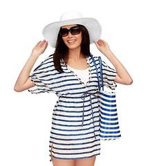 Image showing young woman in striped tunic and sun hat
