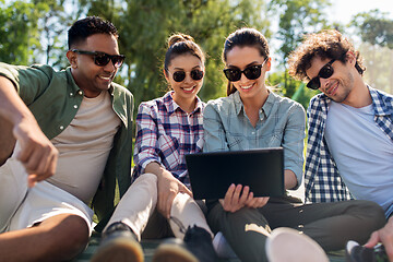 Image showing friends with tablet pc computer outdoors in summer