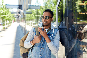 Image showing man recorving voice message on smartphone in city