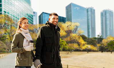 Image showing happy couple walking along autumn tokyo city