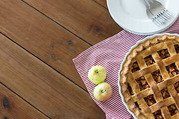 Image showing apple pie in baking mold on wooden table