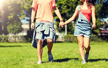 Image showing happy teenage couple walking at summer park