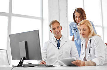 Image showing group of doctors with tablet computer at hospital