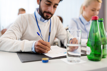 Image showing businessman with papers at business conference