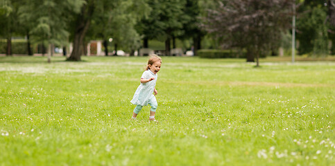 Image showing happy little baby girl running at park in summer