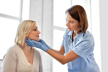 Image showing doctor checking patient\'s tonsils at hospital