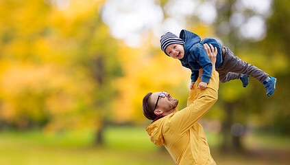 Image showing father with son playing and having fun in autumn