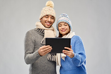 Image showing couple in winter clothes with tablet computer