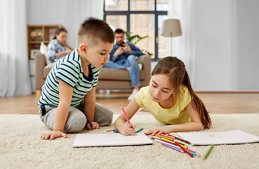 Image showing brother and sister drawing with crayons at home