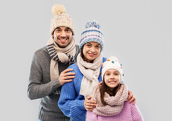 Image showing happy family in winter clothes on grey background