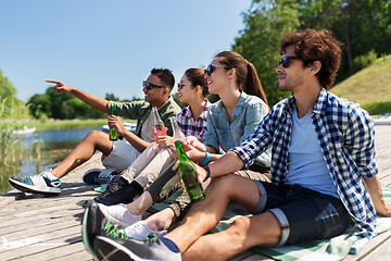 Image showing friends drinking beer and cider on lake pier