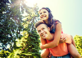 Image showing happy teenage couple having fun at summer park