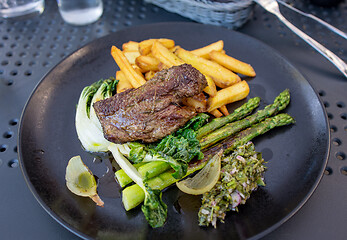 Image showing portion of beef fillet steak with vegetables