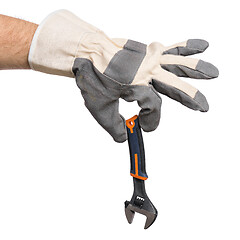 Image showing Hand with glove and adjustable wrench