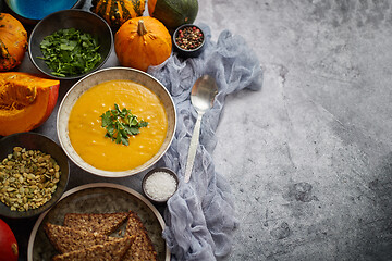 Image showing Pumpkin soup decorated with parsley for Thanksgiving, halloween.