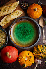 Image showing Empty ceramic bowl and ingredients ready for pumpkin soup. With different kinds of small pumpkins