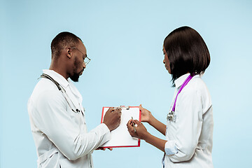 Image showing The female and male f happy afro american doctors on blue background