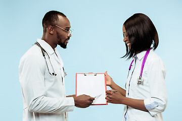 Image showing The female and male f happy afro american doctors on blue background