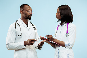 Image showing The female and male f happy afro american doctors on blue background